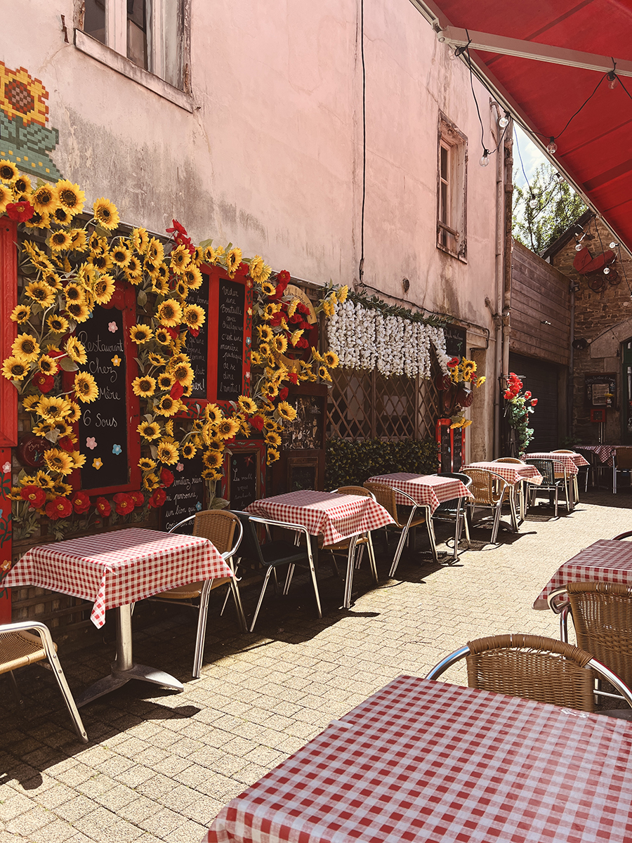 Sunny day in a charming Vannes café with tables set outdoors — inviting scene of French countryside life and relaxed travel moments