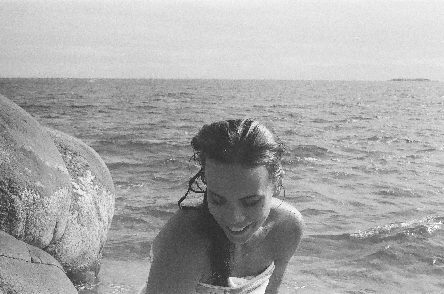 black and white film shot of a woman getting out of the ocean